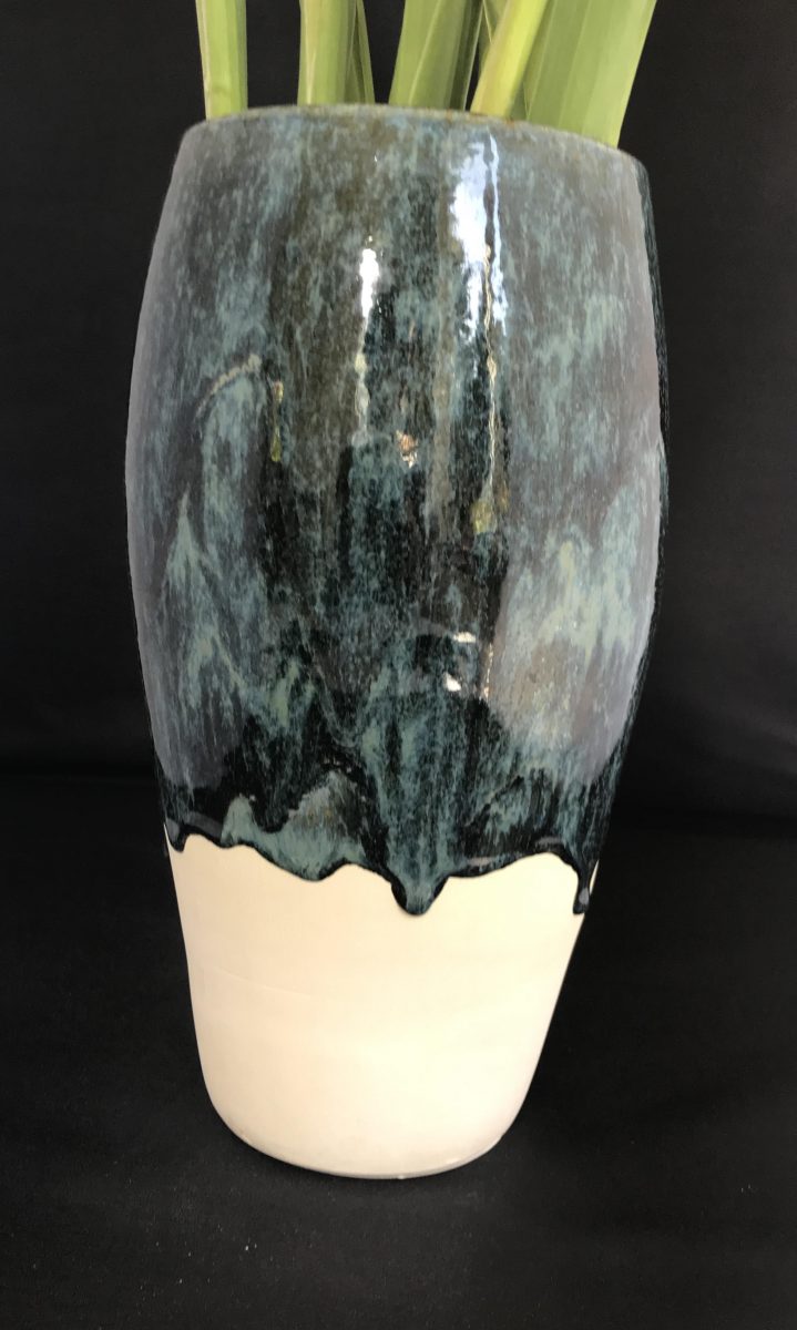 Tall vase, half white and half blue.