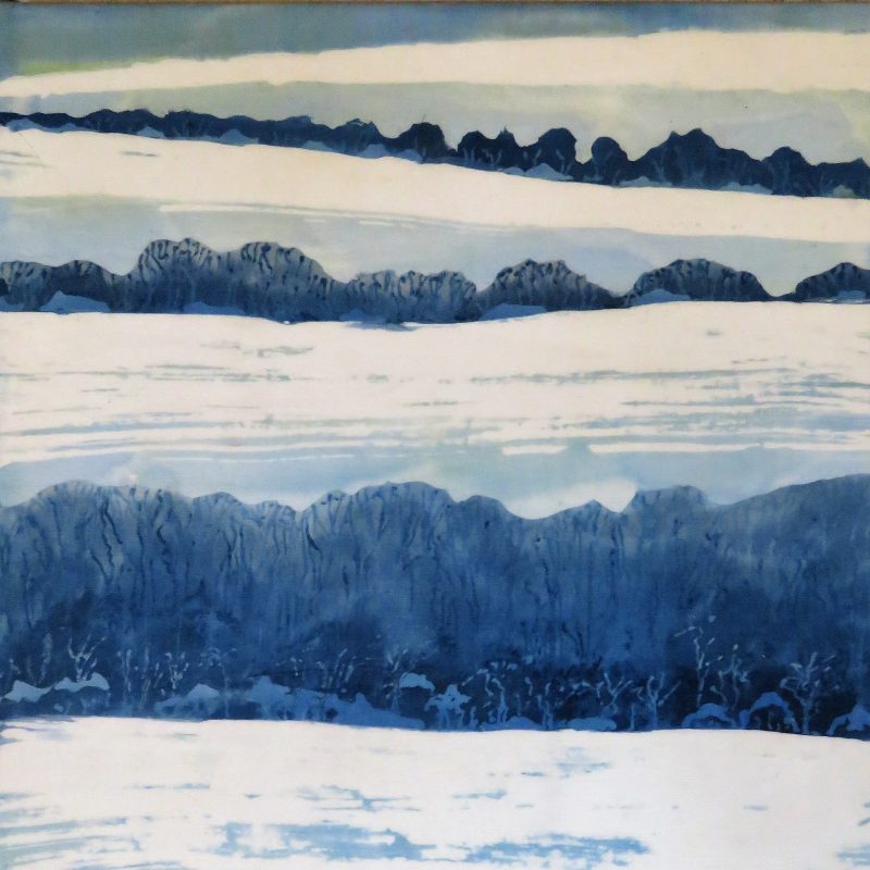 A cotton batik with snow covering The South Downs in shades of blue on white.