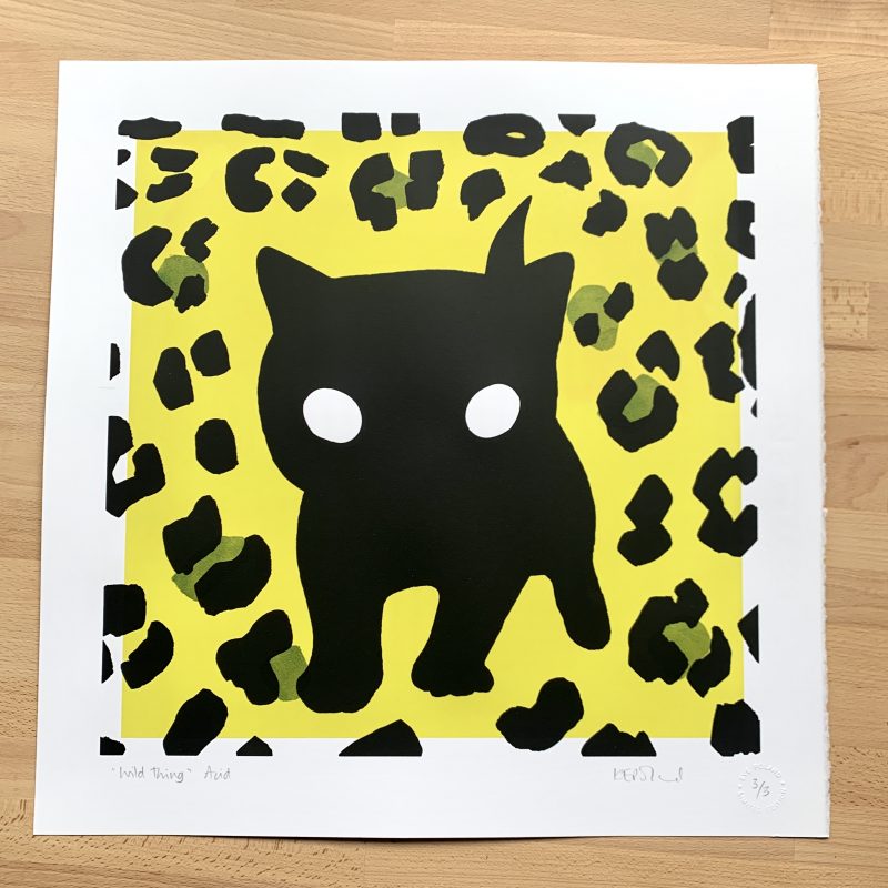 A screenprint: a large black kitten silhouette on a lime green background overlaid with darker green spots and black leopardprint