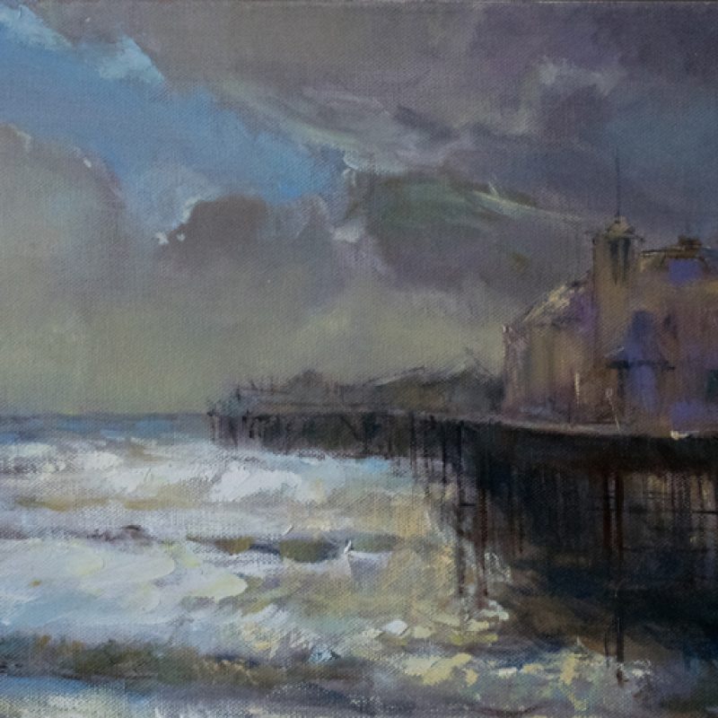 Rain clearing over Palace Pier, revealing sunlight on the sea, October