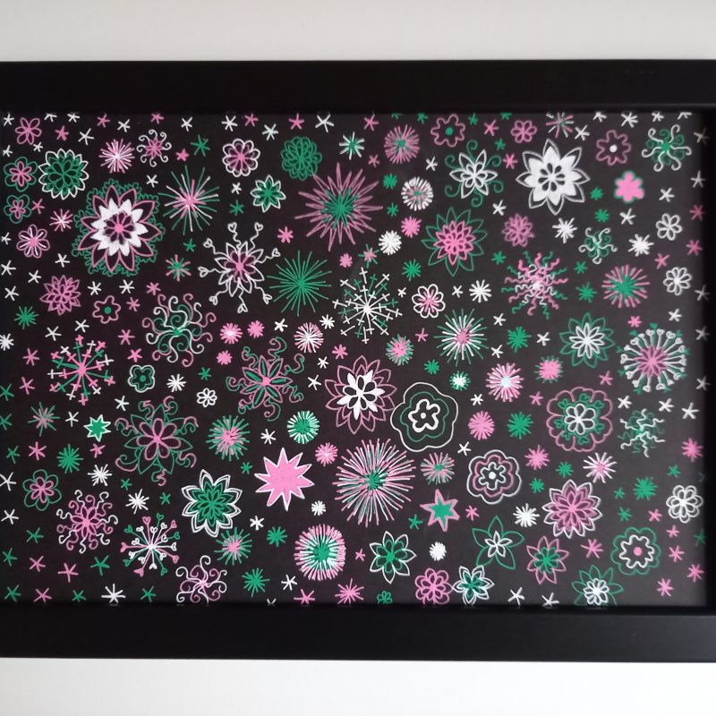 Pink, green and white sparkling abstract image using gel pens on a black background. Lots of small individual star or firework-like shapes which create a larger pattern covering the whole page.