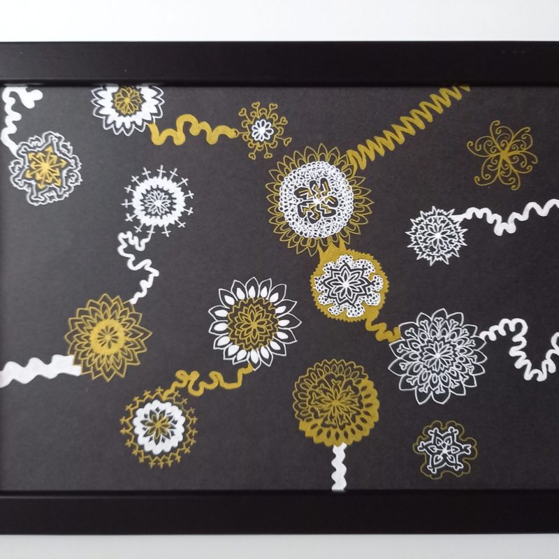 Gold and white drawing using gel pens on black card. Flower-like shapes connected with squiggly swirly lines. Image stands out on black background. 2nd in series.