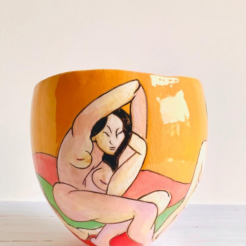 Yellow and orange small organic shaped pot illustrated with female slipware nude