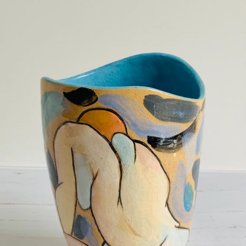 tulip shaped pot, blue inside, illustrated with a slipware female nude 