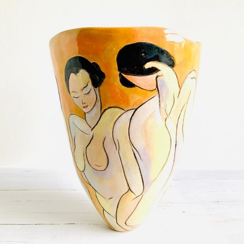 tulip shaped yellow pot, decorated with female nude created with slip.