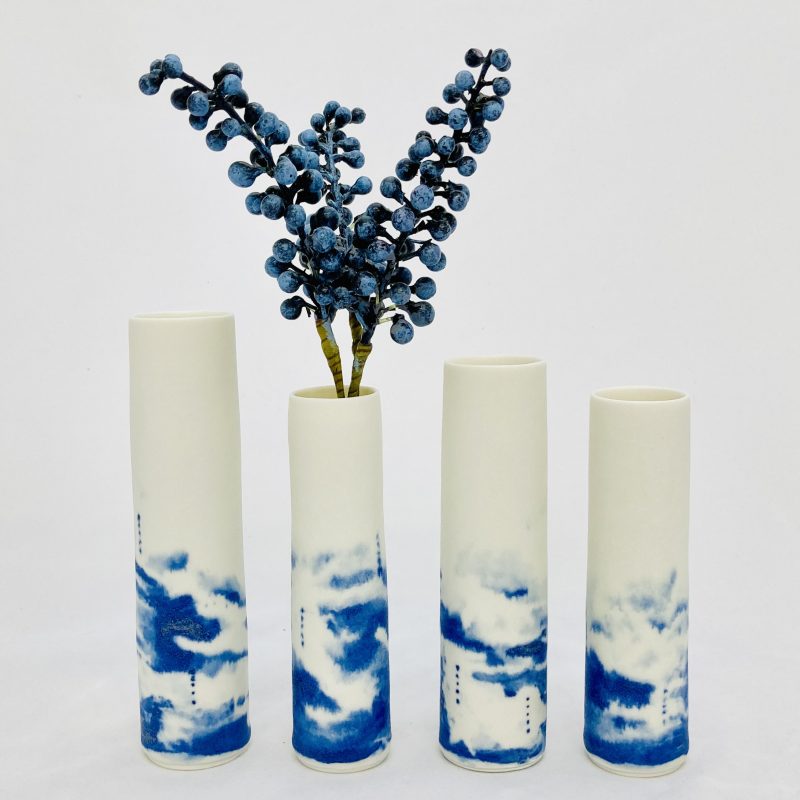 Wheel thrown stem vases with blue sgraffito on satin-matt glaze.  