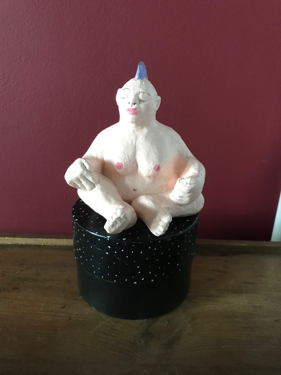 Female Buddha with mohican on round box plinth