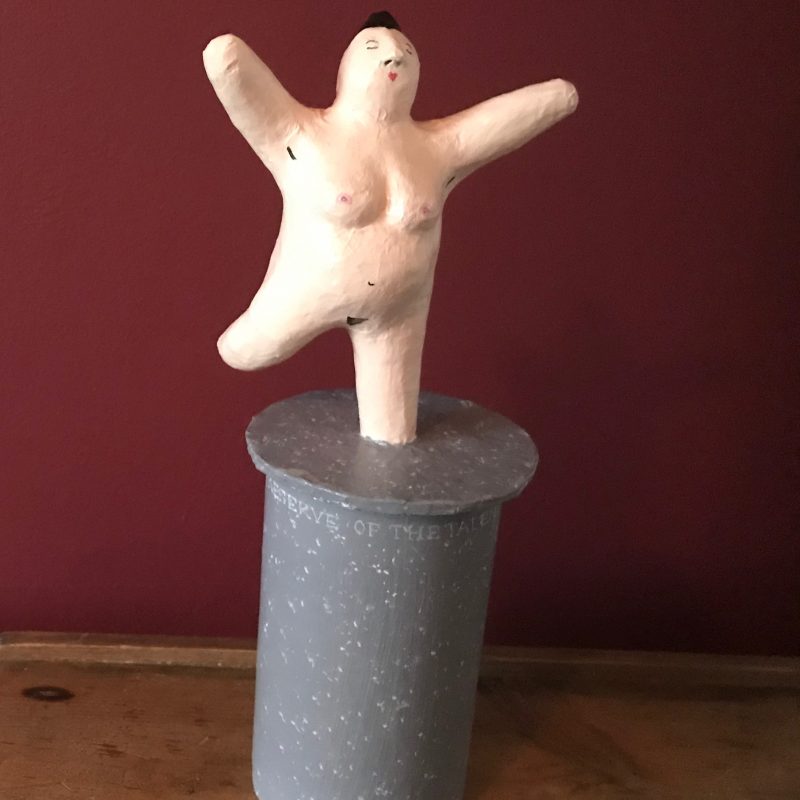 Naked female dancer on a box plinth