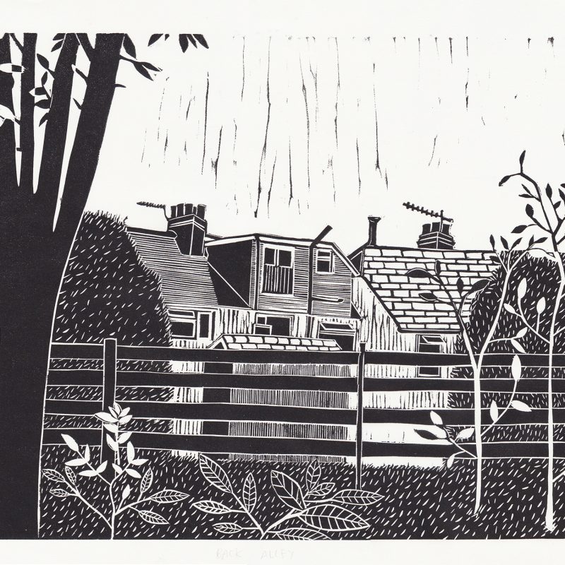 A linocut print of the backs of houses and foliage from an alleyway