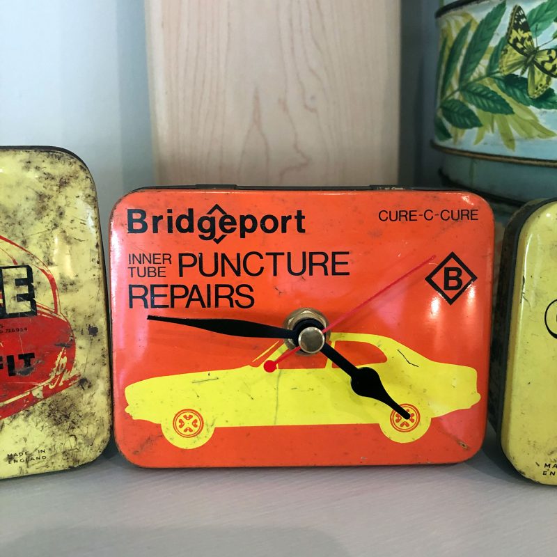 Vintage puncture repair tins made into working clocks