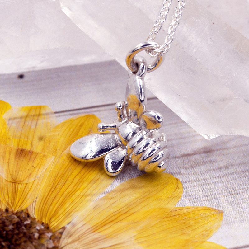 This beautiful silver bee has ridged stripes and shiny wings. He hangs at an angle from one of his outstretched wings and his little legs are tucked under his body. Although small in size, he makes a lovely simple but striking pendant! Who can resist his tiny smiling face?!