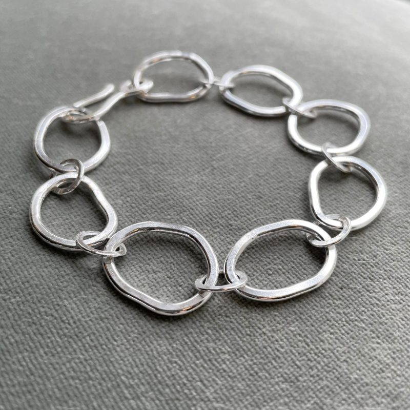 Organically shaped, flattened link Sterling Silver bracelet closed with a hook clasp.