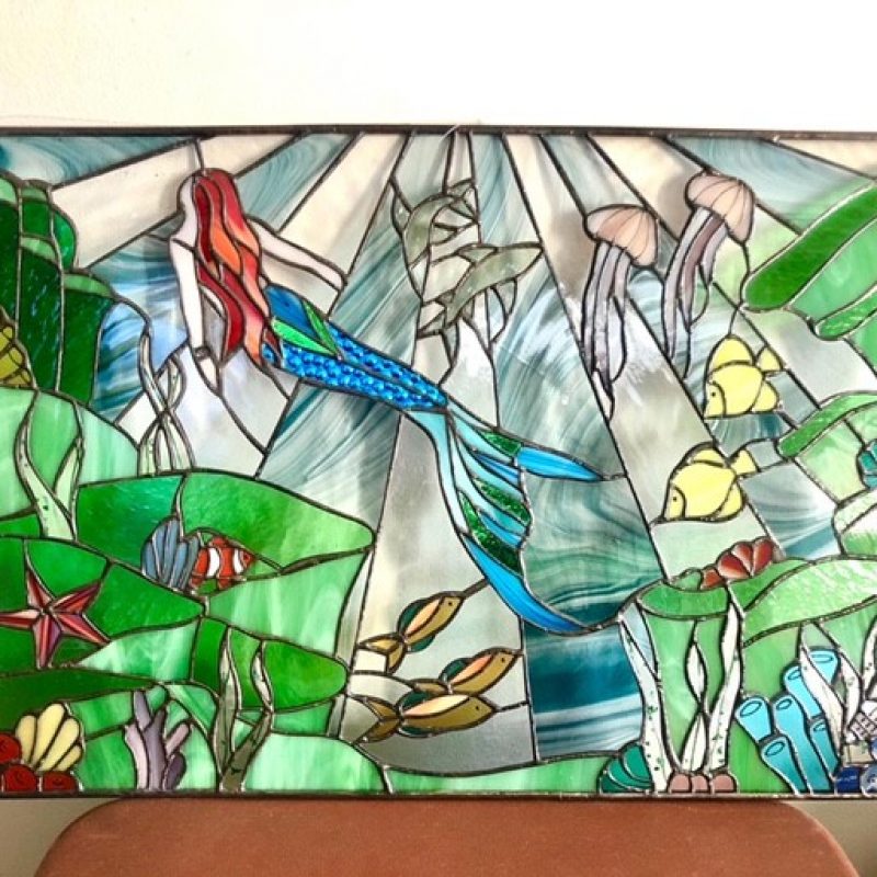 Colourful image of mermaid in stained glass