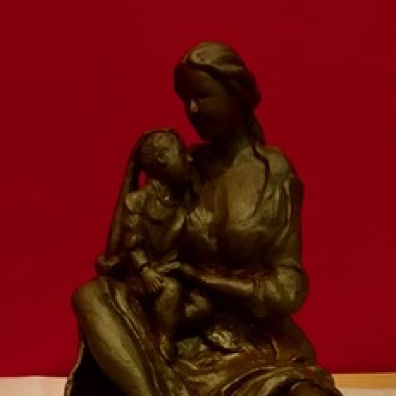 Sculpture mother hugging her child.