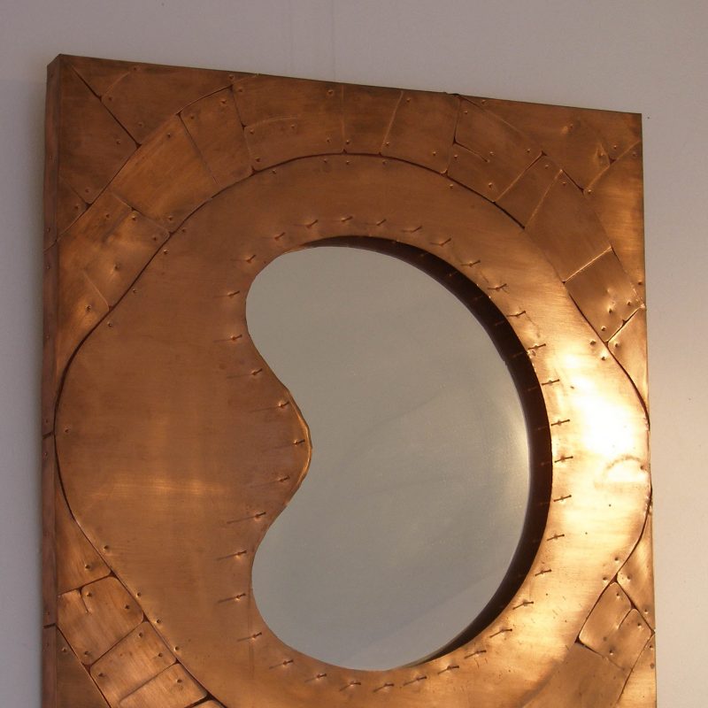 Eye shaped mirror with copper sheet surround