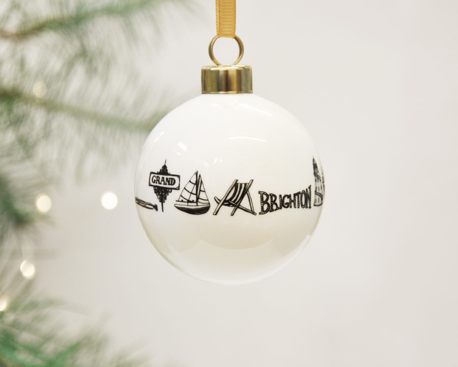 Fine bone china bauble decorated with intricate fine line illustrations of Brighton imagery. 