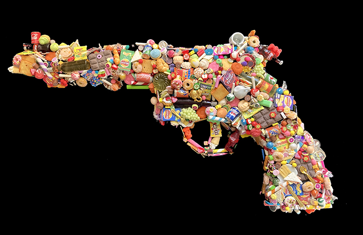 A GUN ENCRUSTED WITH HAND MADE MINIATURE CANDY SWEETS