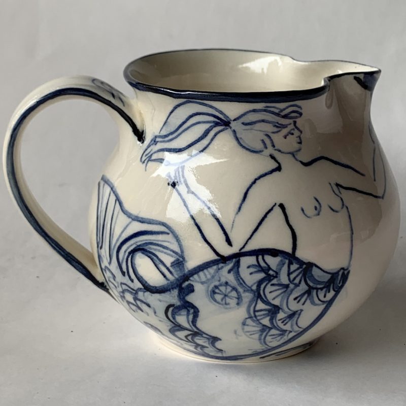 Hand-thrown blue and white brush decorated with mermaids.