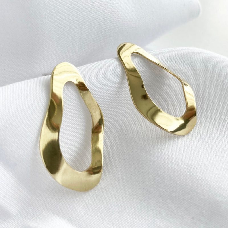 shiny gold oval stud earrings with a ripple effect.