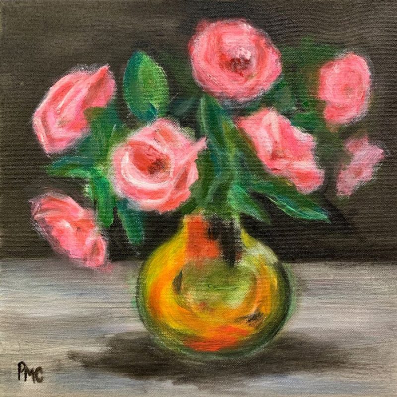 A posse of seven pink roses in an orange glow vase preparing for the tail end of the day 