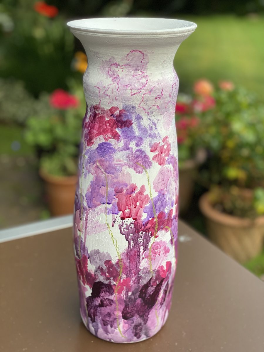 Ceramic vase using air dry clay with an array of abstract sweet peas painted on it