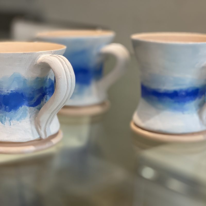 Mugs with an abstract sea scene mainly blue and white