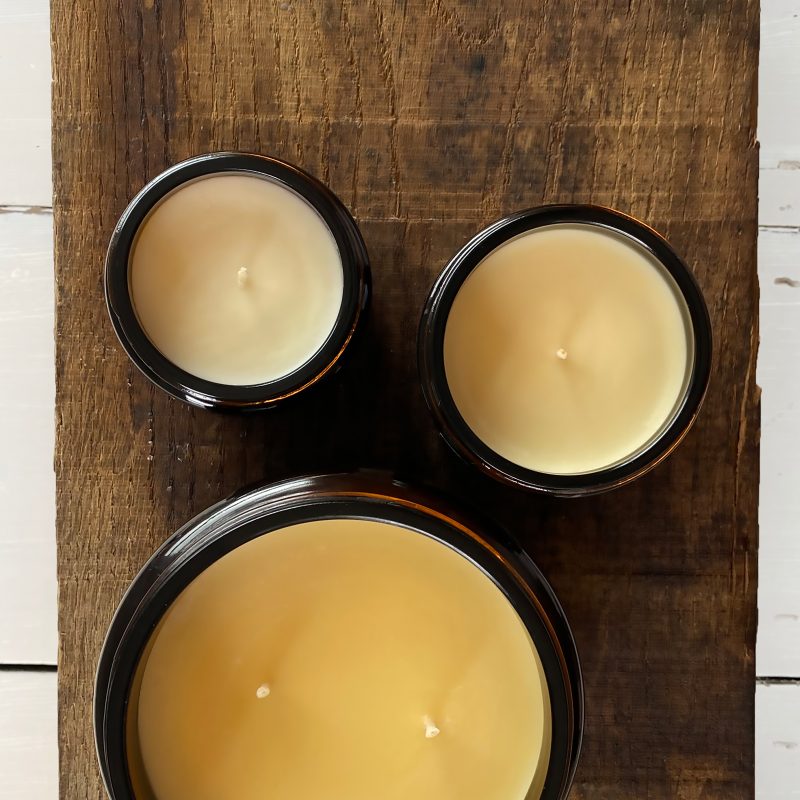 photograph from above of 3 candles in jars