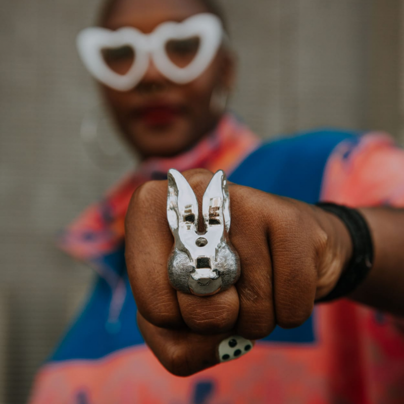 A black woman wearing a rabbit-like silver ring