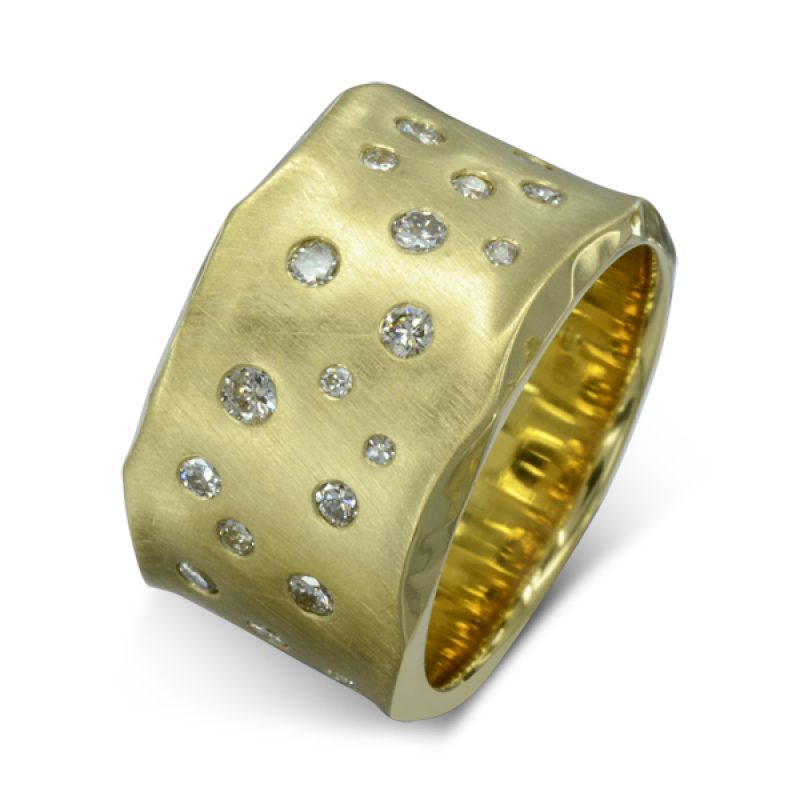a wide band of side hammered gold flush set with different sized round diamonds