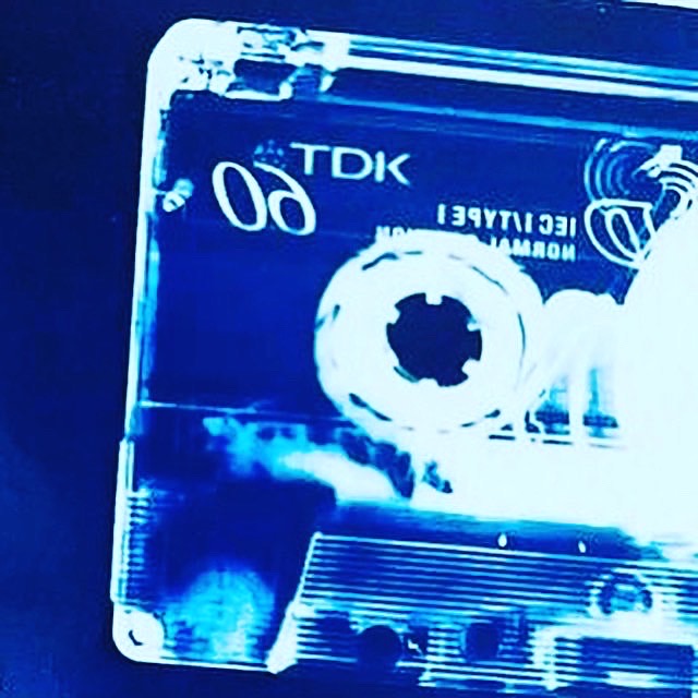 A large negative image of a transparent cassette tape which fills the whole A3 page, produced by using a Cyanotype process, which give a deep rich blue colour. 