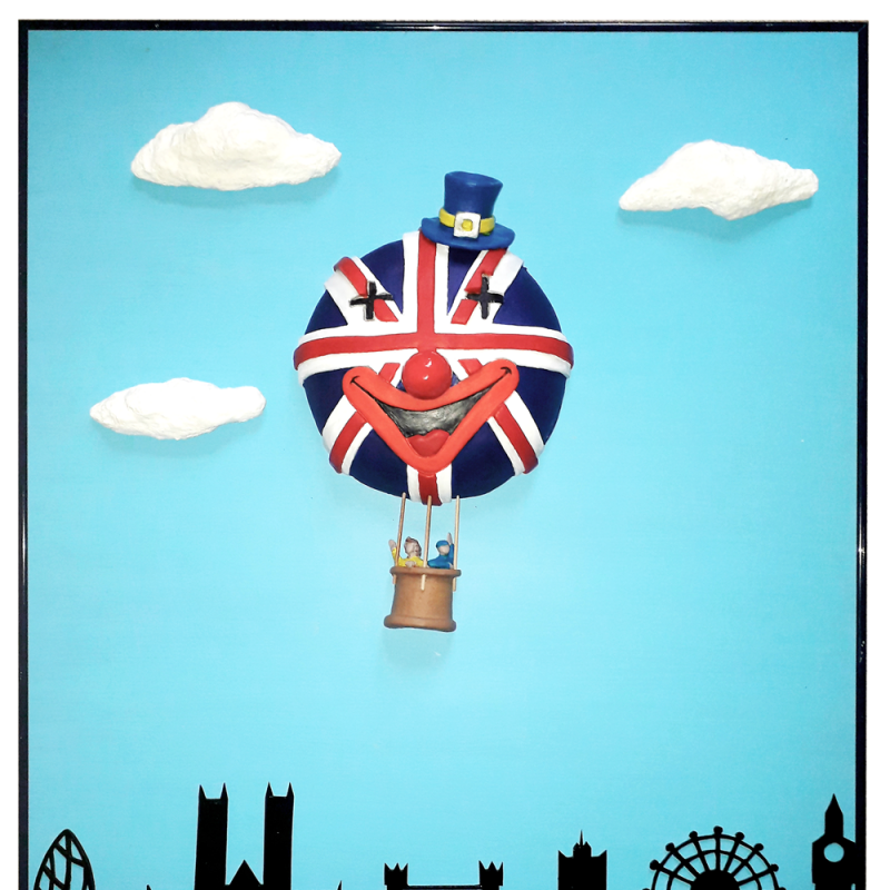Skyline of London with blue sky and a Union Jack air balloon with a face of a clown wearing an EU top hat as The UK fly away from Europe.  