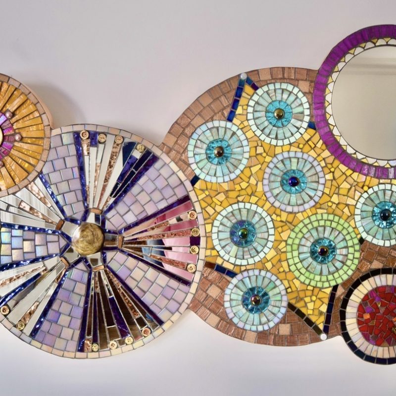 Oblong circular abstract mosaic mirror with stained glass, buttons and shells