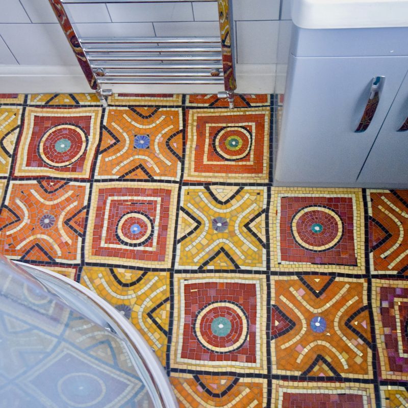 Colourful patchwork floor made form cut glass tiles 