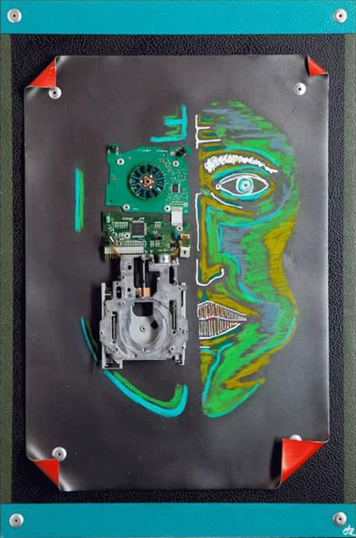 Humanoid  W40cm - H60cm - D2cm A face of a humanoid, half human and half technology . Made of mixed media, computer components and pastels on metal sheeting. Colour: Predominantly green