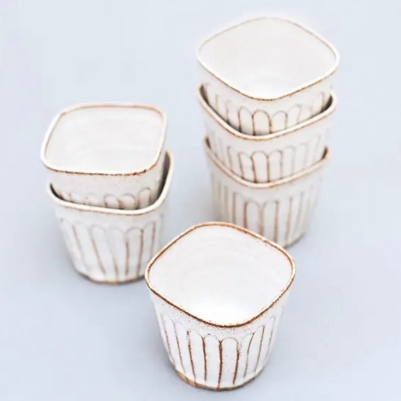 a stack of handcrafted textured espresso tumblers that fit perfectly in your hand. All finished in a glossy white glaze. 