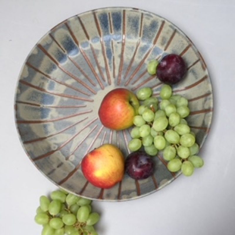 Ceramic bowl with apples, plums and grapes