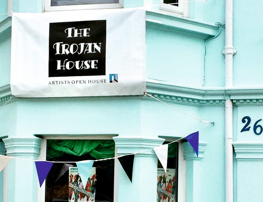 Photograph of the blue front of the Trojan House proudly flying its banner with the AOH logo on it