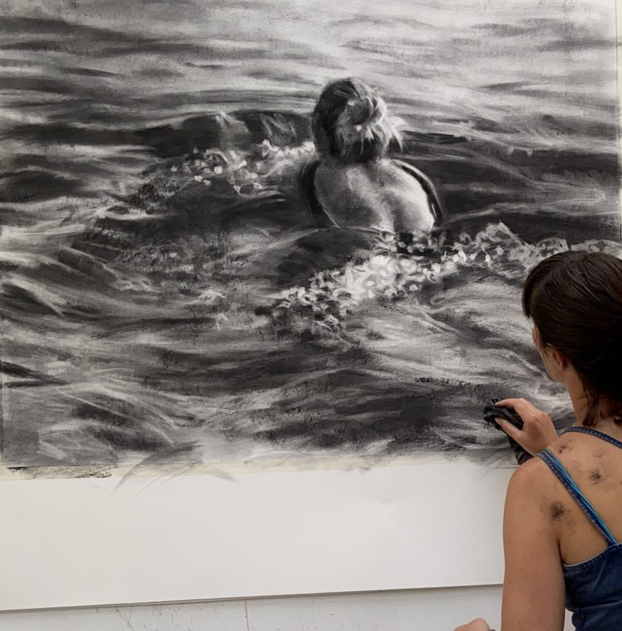  A large charcoal drawing of a female figure swimming through a large expanse of water