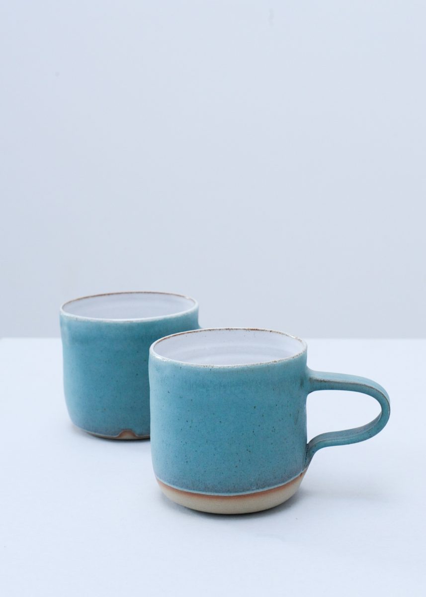 a large mug crafted in stoneware and finished in a turquoise matt glaze, reminiscent of the sea