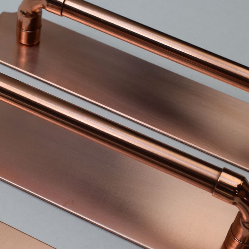 Copper handles with a satin finish on backplates