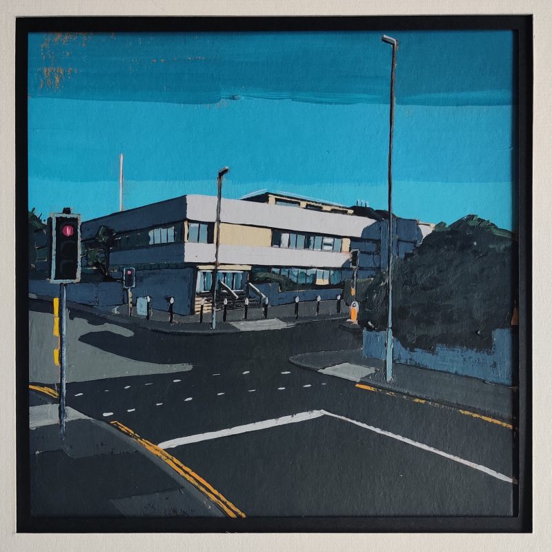 An acrylic painting on a small square canvas of a landscape of local street in Brighton depicting a cross roads with traffic lights, painted road markings, tall thin street lamps & a contemporary 1970s building. The sky is painted with delicious thick blue brushstrokes & the road painting with vibrant yellow double yellow no parking lines. 
