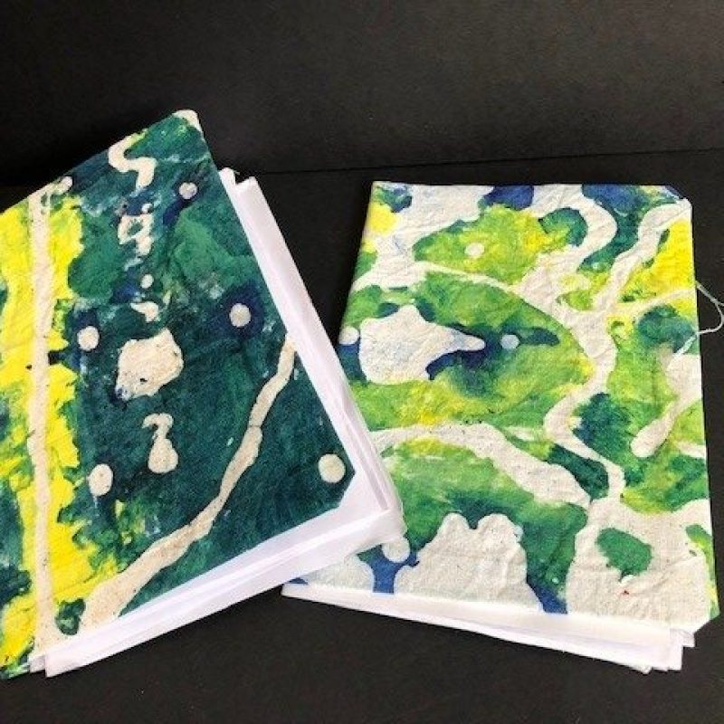 Mini sketchbooks covered in a batik style hand painted cloth inspired by Ankara fabric