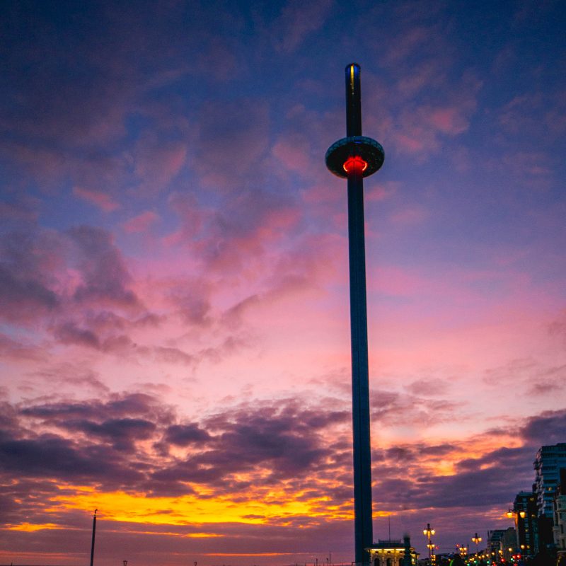 Dramatic colourful sunset; purples, pinks, oranges, with the i360 in view from the upper promenade