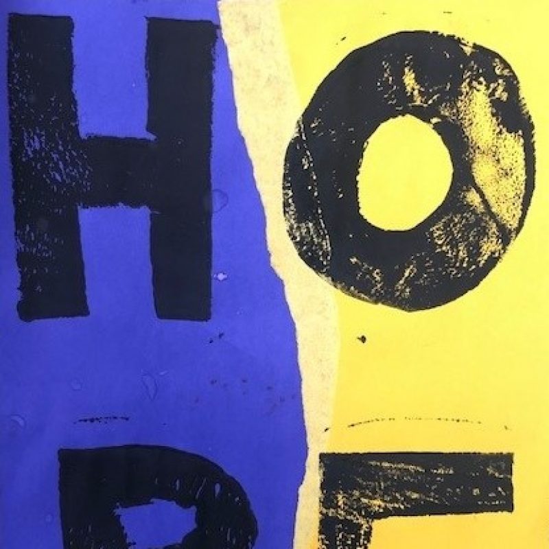 Block letters printed in black ink and arranged in 2 x 2 format spelling HOPE on a torn purple and yellow paper background.