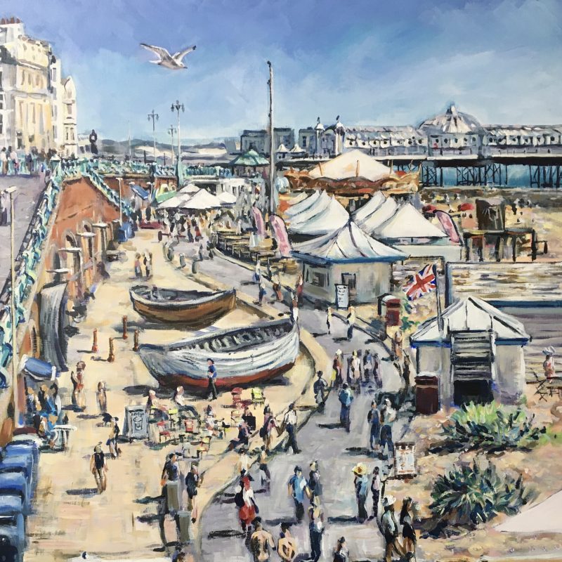 Classic view of Brighton seafront. Depicting cafes, the fishing quarter and the Palace Pier. Crowds of people walk along the sunlit promenade. A seagull flys overhead