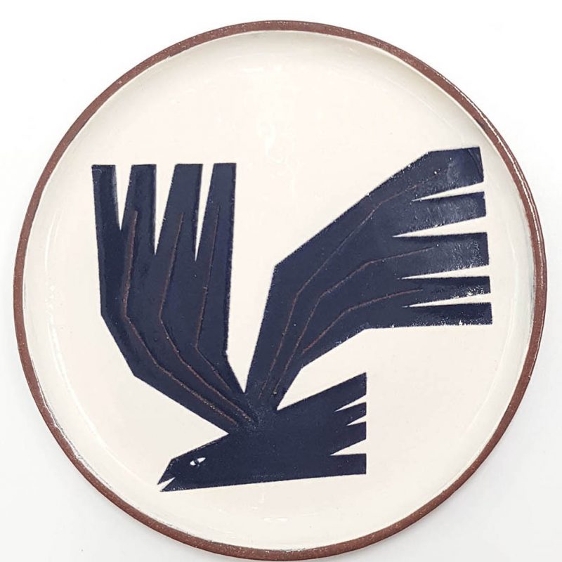 A ceramic plate with an image of a rook on it