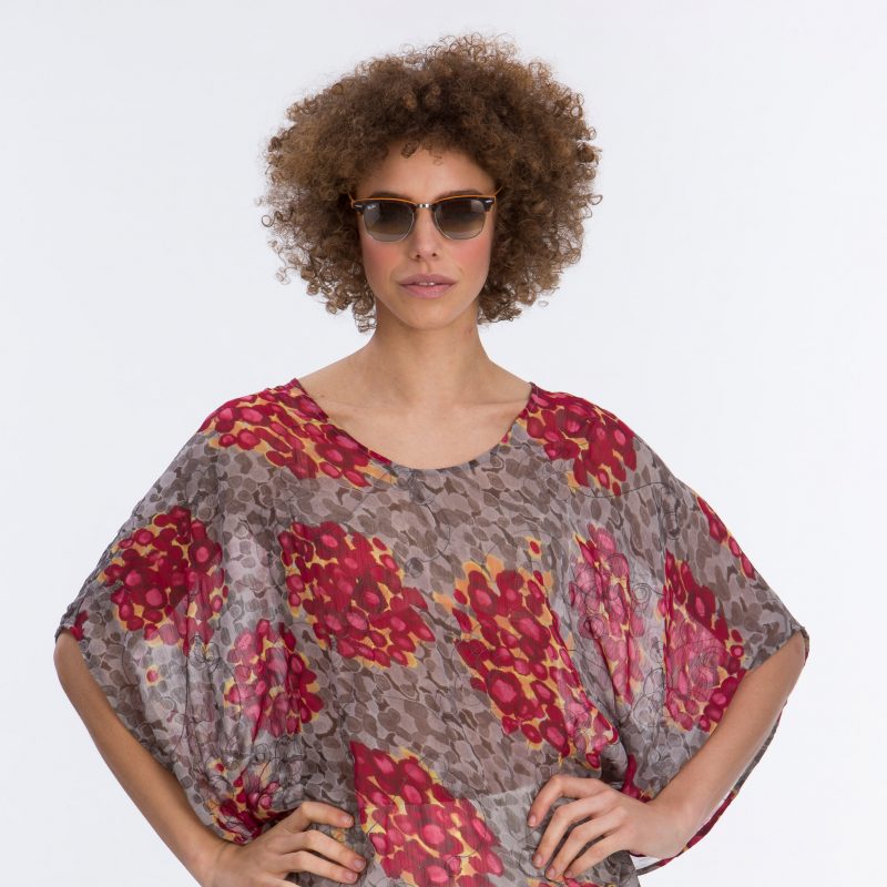 Lady wearing coloured patterned chiffon top 