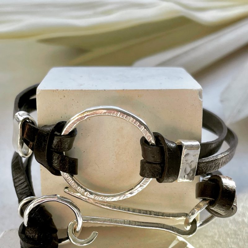 Handmade bracelet with silver and leather. It's composed by a ring with hammer texture and the leather wraps your wrist and it's fastened with a lovely hammered texture silver clasp. It fits beautifully around your wrist and it’s an easy wear piece of jewellery. This is a boho design using different materials.