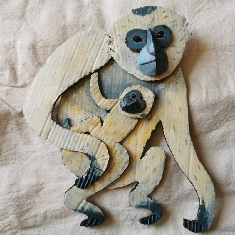 A painted cardboard piece of gibbon monkey and her baby