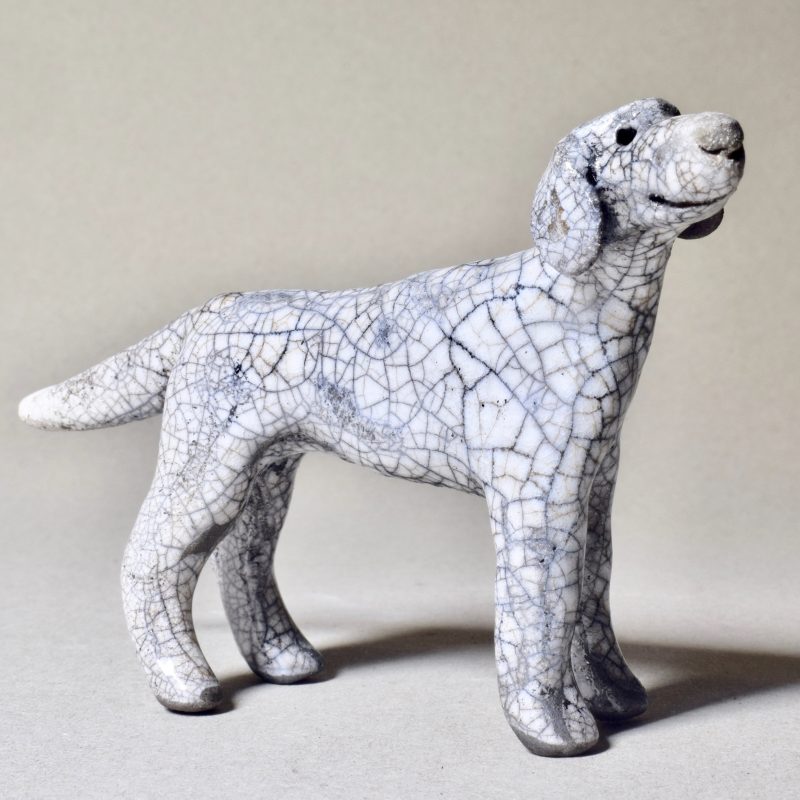 A small ceramic sculpture of a dog